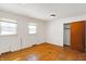 A bedroom with wood floors, closet, two windows and baseboard heat at 6838 Hague Rd, Indianapolis, IN 46256