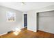 Bedroom with wood floors, closet, window, and ceiling light at 6838 Hague Rd, Indianapolis, IN 46256