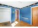 Bedroom features unique border, blue walls, and hardwood floors at 6838 Hague Rd, Indianapolis, IN 46256