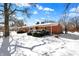 Well-maintained brick home with a tidy front yard and trimmed bushes during winter at 6838 Hague Rd, Indianapolis, IN 46256