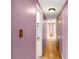 Hallway with original hardwood floors and neutral wall paint that offers access to other rooms in the home at 6838 Hague Rd, Indianapolis, IN 46256