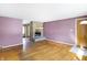 Spacious living room featuring hardwood floors, stone fireplace, and natural light at 6838 Hague Rd, Indianapolis, IN 46256