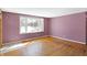 Sunlit living room featuring hardwood floors and a view of the snowy outdoors at 6838 Hague Rd, Indianapolis, IN 46256