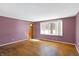 Bright living room with hardwood floors, large window, and ample natural light at 6838 Hague Rd, Indianapolis, IN 46256