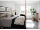 Bright bedroom featuring a four-poster bed, natural light, and plant in a woven basket at 720 Keck Way, Westfield, IN 46074