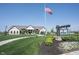 Inviting clubhouse exterior featuring manicured landscaping, a lush green lawn, and an American flag waving in the breeze at 720 Keck Way, Westfield, IN 46074