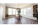 Inviting dining area with a modern chandelier and natural light from large windows at 720 Keck Way, Westfield, IN 46074