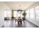 Bright dining area with round table, modern lighting, and large windows with outdoor views at 720 Keck Way, Westfield, IN 46074
