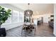 Bright dining area with backyard view and a modern decorative light fixture at 720 Keck Way, Westfield, IN 46074