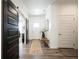 Bright foyer with sliding barn door, neutral walls, stylish rug, and wood-look flooring at 720 Keck Way, Westfield, IN 46074