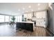 Modern kitchen features an island with seating, stainless appliances, and an open concept layout at 720 Keck Way, Westfield, IN 46074