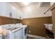 Laundry room featuring full-size washer and dryer, modern hooks, and sleek wood flooring at 720 Keck Way, Westfield, IN 46074