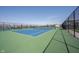 A pristine blue and green tennis court, enclosed with a fence, ready for a competitive match at 720 Keck Way, Westfield, IN 46074