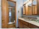 Bathroom features a stylish vanity, marble countertop, and glass-enclosed shower at 7579 Allenwood Ct, Indianapolis, IN 46268