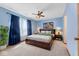 Comfortable bedroom featuring blue walls, a ceiling fan, and natural light at 7579 Allenwood Ct, Indianapolis, IN 46268