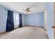 Bright bedroom features plush carpet, ceiling fan, and natural light from the window at 7579 Allenwood Ct, Indianapolis, IN 46268