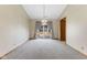 Empty dining area with neutral carpet, simple lighting fixture and sliders to the backyard at 7579 Allenwood Ct, Indianapolis, IN 46268