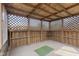 Unfurnished screened-in gazebo interior with carpeting and lattice-patterned walls at 7579 Allenwood Ct, Indianapolis, IN 46268