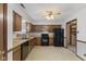 Functional kitchen featuring wood cabinets, black appliances, and plenty of counter space at 7579 Allenwood Ct, Indianapolis, IN 46268