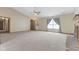 Open living room with vaulted ceilings, neutral carpet, and lots of natural light at 7579 Allenwood Ct, Indianapolis, IN 46268