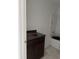 Bathroom featuring a dark vanity and a white bathtub at 7622 Sebastian Pl, Indianapolis, IN 46239