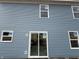 A view of the blue exterior elevation with windows and a sliding door at 7622 Sebastian Pl, Indianapolis, IN 46239