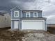 Two-story home with blue siding, white trim, and a two-car garage, new construction at 7622 Sebastian Pl, Indianapolis, IN 46239