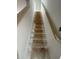 Staircase featuring a wooden handrail, connecting two levels of the home at 7622 Sebastian Pl, Indianapolis, IN 46239
