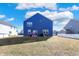 Exterior view of a blue two-story home with a spacious, open backyard at 8148 Ebaugh Dr, Camby, IN 46113