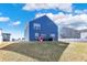 Back exterior of a blue two-story house with a wide grassy yard and partly cloudy sky at 8148 Ebaugh Dr, Camby, IN 46113