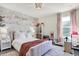 Charming bedroom with floral wallpaper, plush bedding, and playful decor creates a whimsical atmosphere at 8148 Ebaugh Dr, Camby, IN 46113