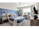 Inviting bedroom with a blue accent wall, airplane wallpaper, a sleek desk, and modern decor at 8148 Ebaugh Dr, Camby, IN 46113