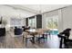 Open concept living and dining area with modern chandelier and sliding glass doors to the backyard at 8148 Ebaugh Dr, Camby, IN 46113