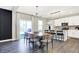 Well-lit dining area with modern lighting, adjacent to a stylish and functional kitchen at 8148 Ebaugh Dr, Camby, IN 46113