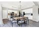 Bright dining area with modern chandelier, adjacent to a well-equipped kitchen at 8148 Ebaugh Dr, Camby, IN 46113