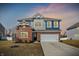 Attractive two-story home with brick accents, a two-car garage, and a well-maintained lawn at 8148 Ebaugh Dr, Camby, IN 46113