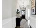 Inviting hallway features a decorative mirror, stylish runner rug, and modern light fixture at 8148 Ebaugh Dr, Camby, IN 46113