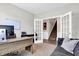 Home office featuring a modern desk, white french doors leading to a staircase at 8148 Ebaugh Dr, Camby, IN 46113
