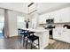 Modern kitchen featuring white cabinets, stainless steel appliances, a spacious island and hardwood flooring at 8148 Ebaugh Dr, Camby, IN 46113