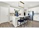 Modern kitchen with stainless steel appliances, white cabinets, and a large island with breakfast bar seating at 8148 Ebaugh Dr, Camby, IN 46113