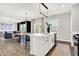 Kitchen island with a sink and stainless steel appliances, plus an open dining and living space at 8148 Ebaugh Dr, Camby, IN 46113