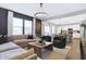Inviting living room featuring a large sectional, modern lighting, and open floor plan at 8148 Ebaugh Dr, Camby, IN 46113