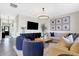 Bright living room with ample seating, modern lighting, and seamless flow to entry way at 8148 Ebaugh Dr, Camby, IN 46113