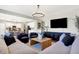 Open-concept living room with comfortable seating, modern lighting, and seamless flow to kitchen at 8148 Ebaugh Dr, Camby, IN 46113