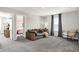 Relaxing living room featuring a comfortable couch, a cozy armchair, and connecting doorway to another bedroom at 8148 Ebaugh Dr, Camby, IN 46113