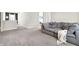 Spacious living room with a comfortable couch and neutral decor, ideal for relaxing and entertaining guests at 8148 Ebaugh Dr, Camby, IN 46113