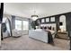 Elegant main bedroom featuring a decorative chandelier, dark accent wall and a cozy seating area at 8148 Ebaugh Dr, Camby, IN 46113