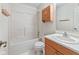 Bathroom with a shower-tub combination and a wooden vanity with a sink at 817 Delray Dr, Indianapolis, IN 46241