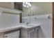 Bathroom with a white sink, white tiled walls, and white cabinets at 8220 Linda Leigh Ln, Indianapolis, IN 46217