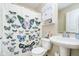 Cozy bathroom with butterfly shower curtain, a white sink, and a mirrored medicine cabinet at 8654 Arailia Dr, Plainfield, IN 46168